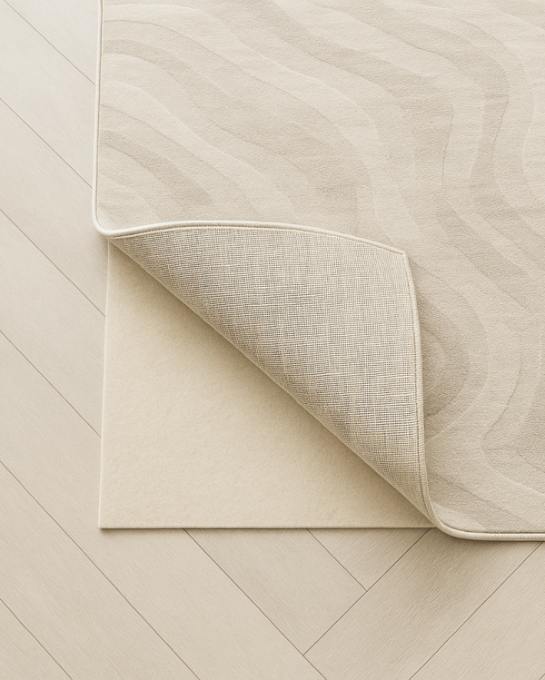 Rug corner lifted to show beige underlay beneath, with woven rug backing visible